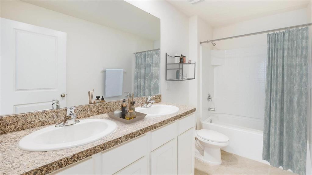 3022 Rock Sound Street Bradenton, FL 34208 - Photo 7 of 13 a bathroom with a granite countertop sink a toilet and shower