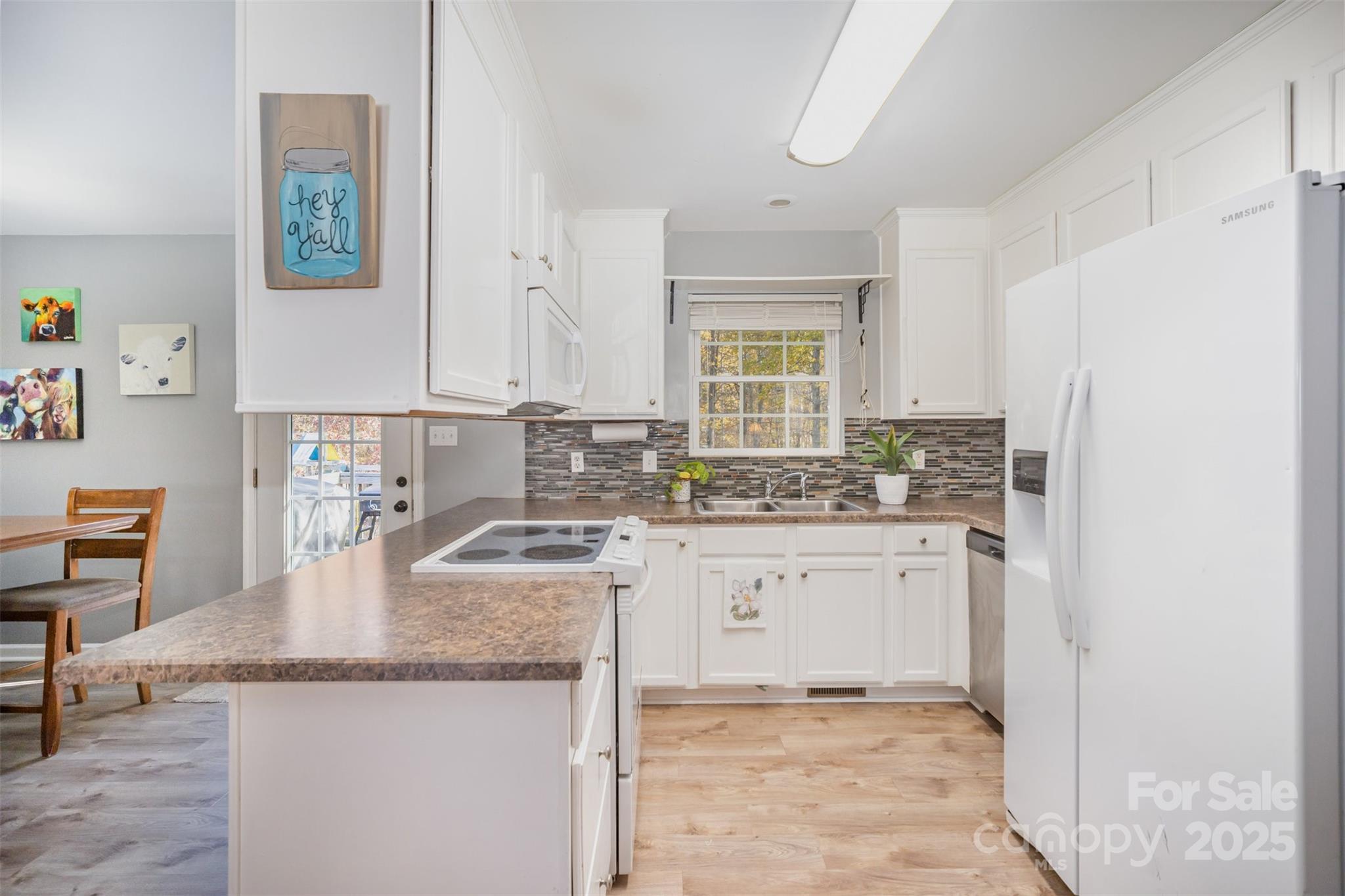 522 Kittiewake Lane Clover, SC 29710 - Photo 13 of 33 a kitchen with granite countertop a sink a stove a refrigerator and island