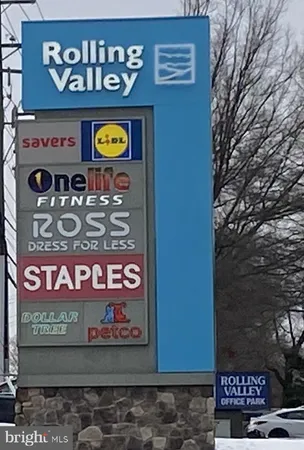 a sign on a wall next to a road