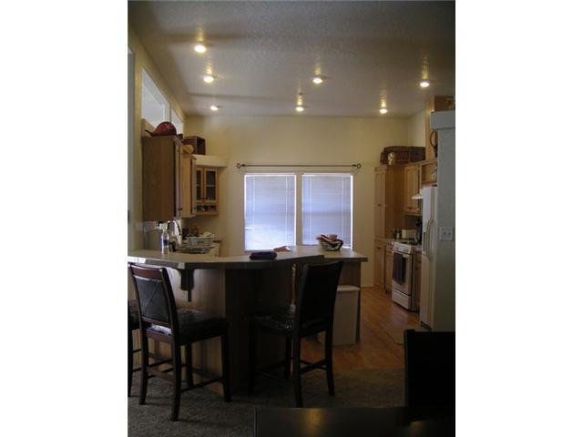 20591 Bee Valley Road Jamul, CA 91935 - Photo 4 of 9 Large kitchen with breakfast bar, island, tons of storage and cutawy into the family room. Canned ceiling lights, newer sink anda pull out faucet and garbage disposal