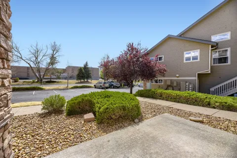 a view of road with house and car parked in front of it