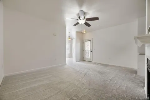 a view of an empty room with a fan