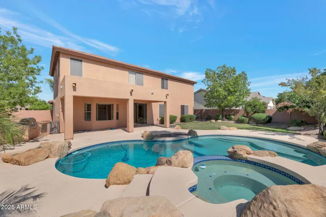 a view of a house with swimming pool and sitting area