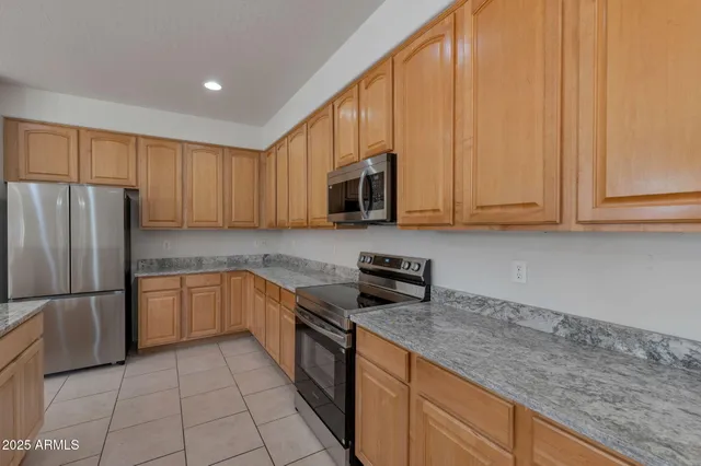 a kitchen with kitchen island granite countertop a sink and chandelier