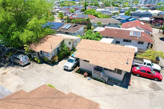 an aerial view of a house with a yard basket ball court and outdoor seating