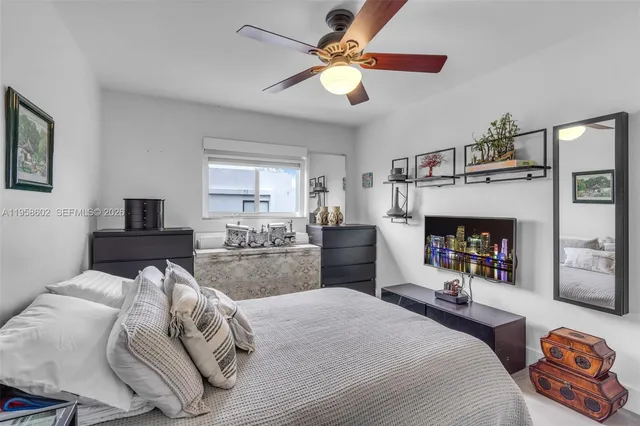 a bedroom with a bed a couch and a fireplace