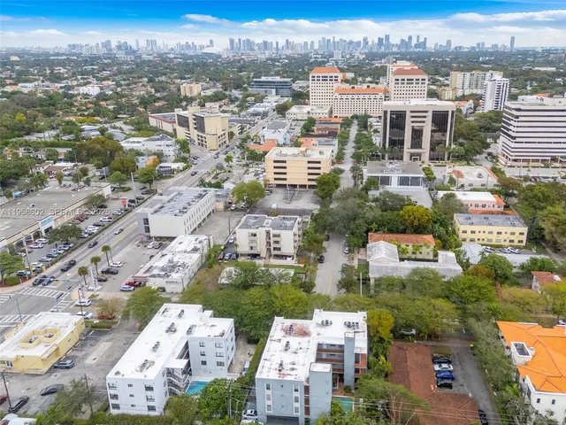 an aerial view of residential houses with city view