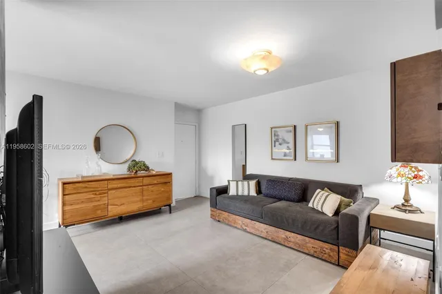 a living room with furniture and a book shelf