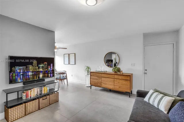 a living room with furniture a couch and a chandelier
