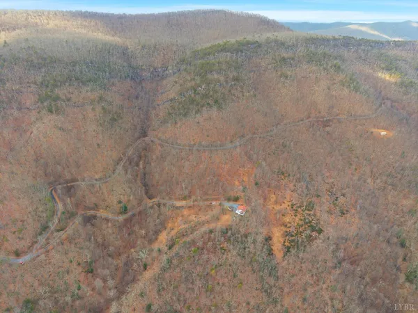 a bathroom with a tub and a view of living room