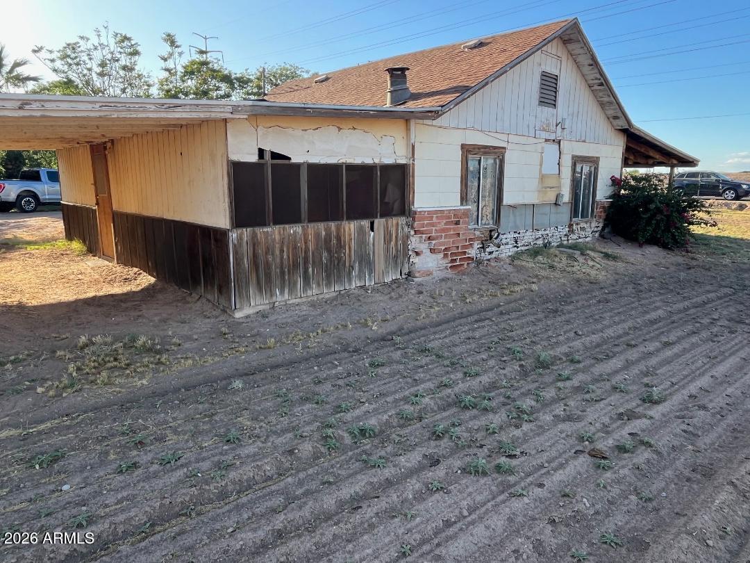 9115 West Broadway Road Tolleson, AZ 85353 - Photo 9 of 13 a front view of a house with a yard