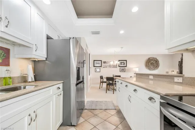 a kitchen with granite countertop a sink appliances and cabinets