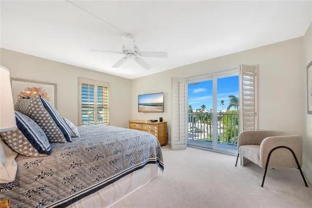 a bedroom with a large bed and a large window