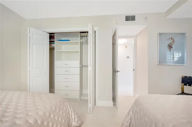 a bedroom with a bed and a view of bathroom