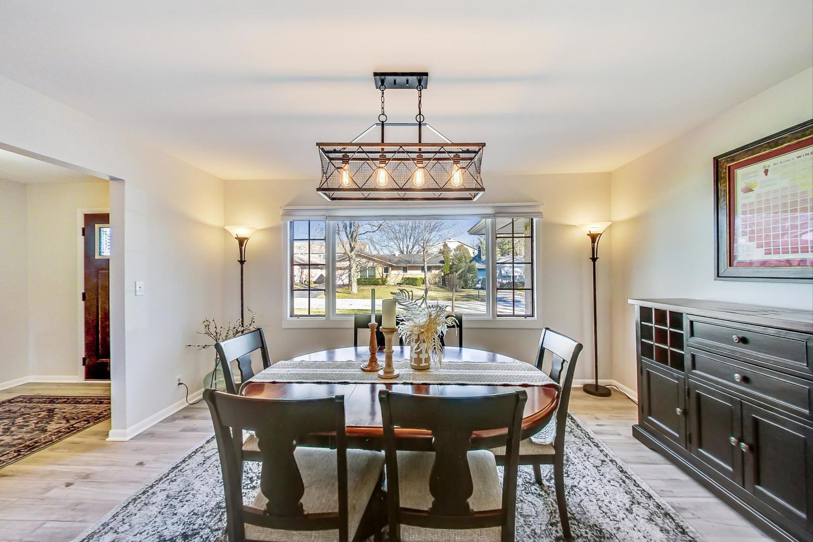 1610 Meadows Road Geneva, IL 60134 - Photo 6 of 28 a view of a dining room with furniture wooden floor and chandelier