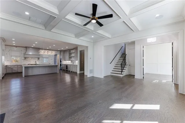 a kitchen with a sink cabinets and wooden floor