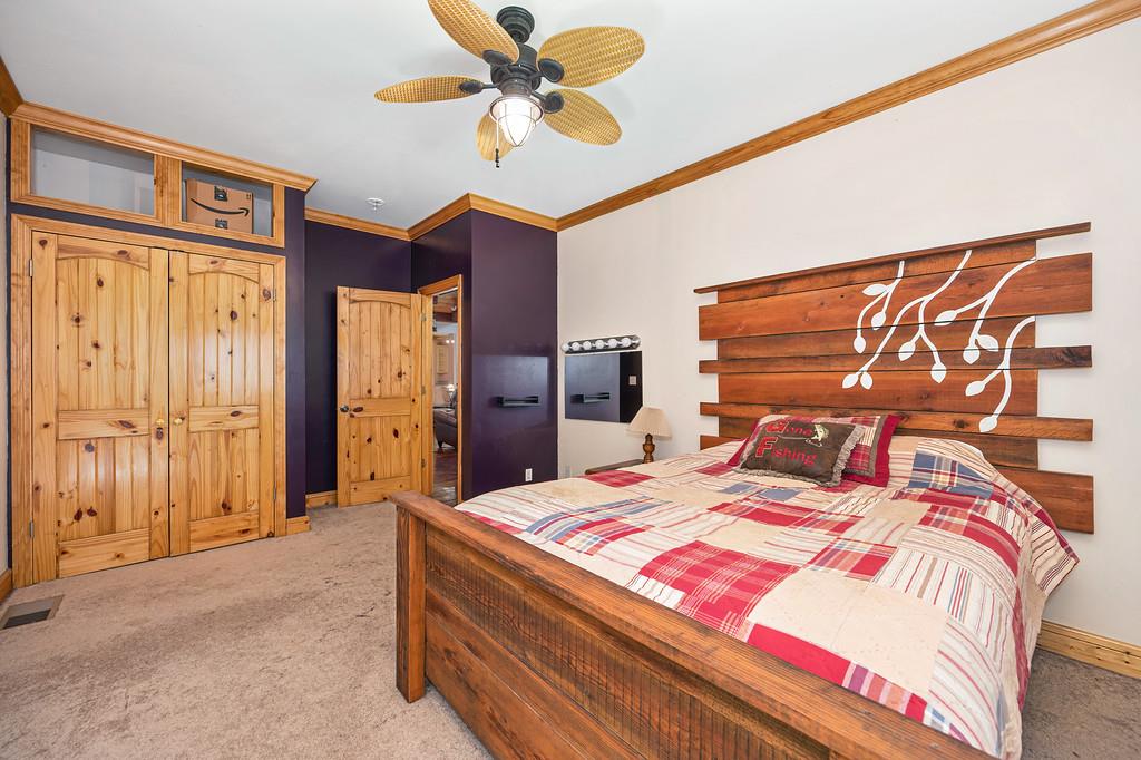 701 Sawmill Road Alta, CA 95701 - Photo 22 of 53 a bedroom with a bed and a chandelier