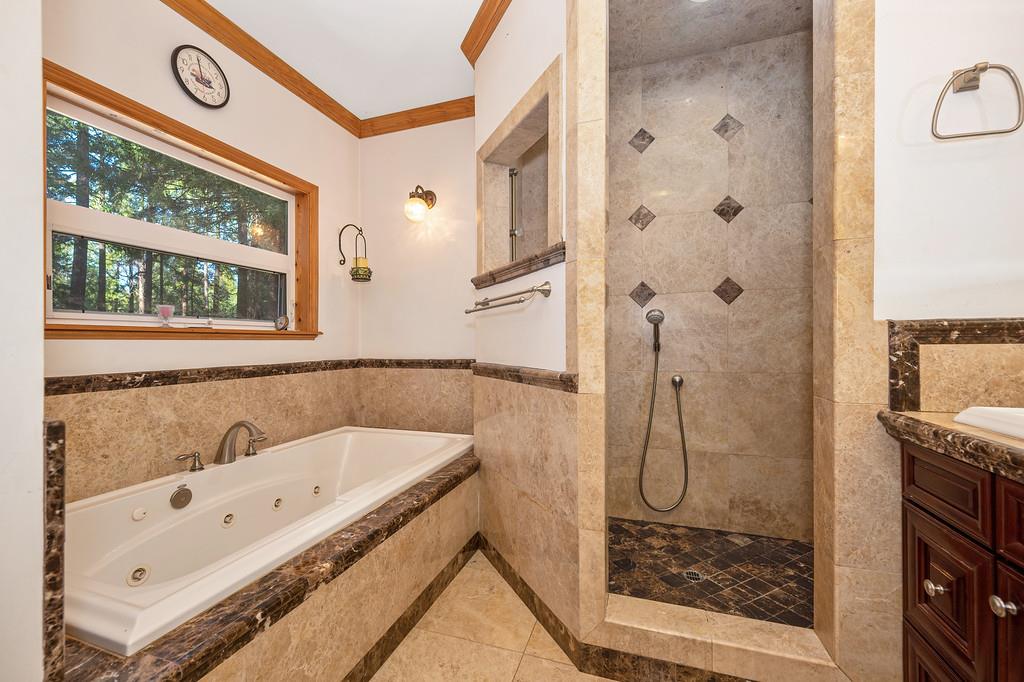 701 Sawmill Road Alta, CA 95701 - Photo 29 of 53 a bathroom with a tub a sink and a shower
