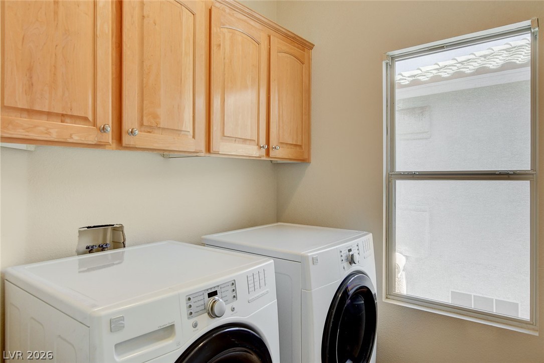 191 Verde Ridge Court Henderson, NV 89012 - Photo 31 of 36 Laundry room with separate washer and dryer, cabinet space, and healthy amount of natural light