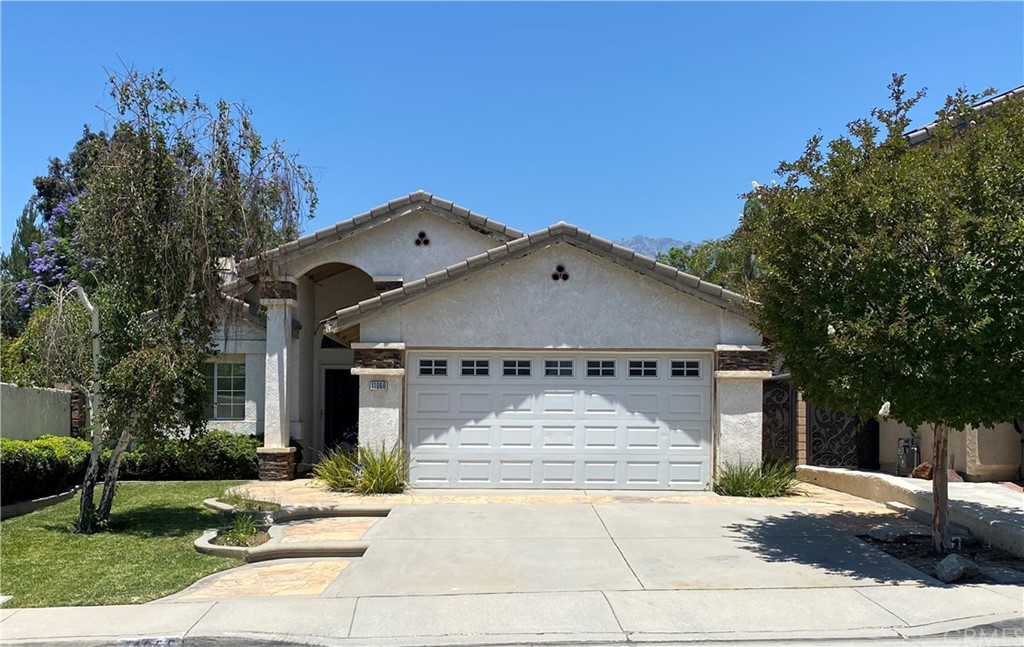 11066 Delaware Street Rancho Cucamonga, CA 91701 - Photo 1 of 1 a front view of a house with a yard