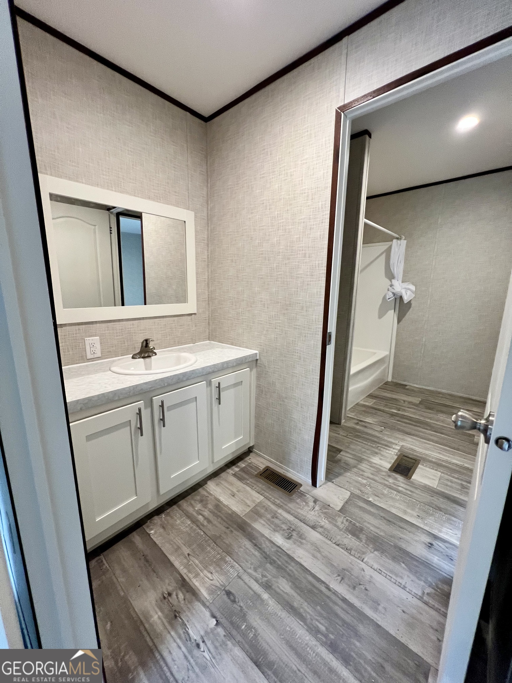 223 Pelican Road Woodbine, GA 31569 - Photo 12 of 18 a bathroom with a sink and mirror