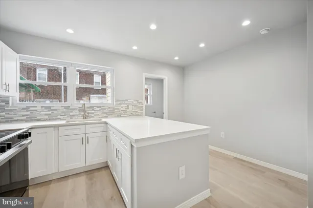 a kitchen with sink cabinets and wooden floor