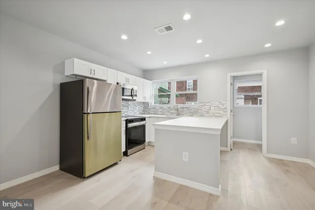 a kitchen with a refrigerator a sink and a stove