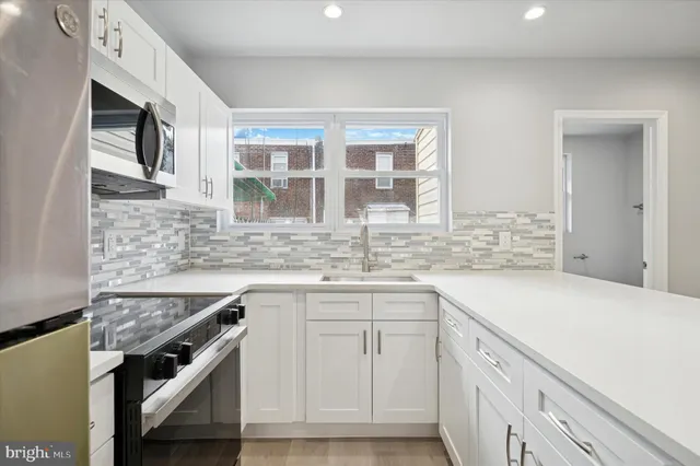 a kitchen with a sink cabinets and window