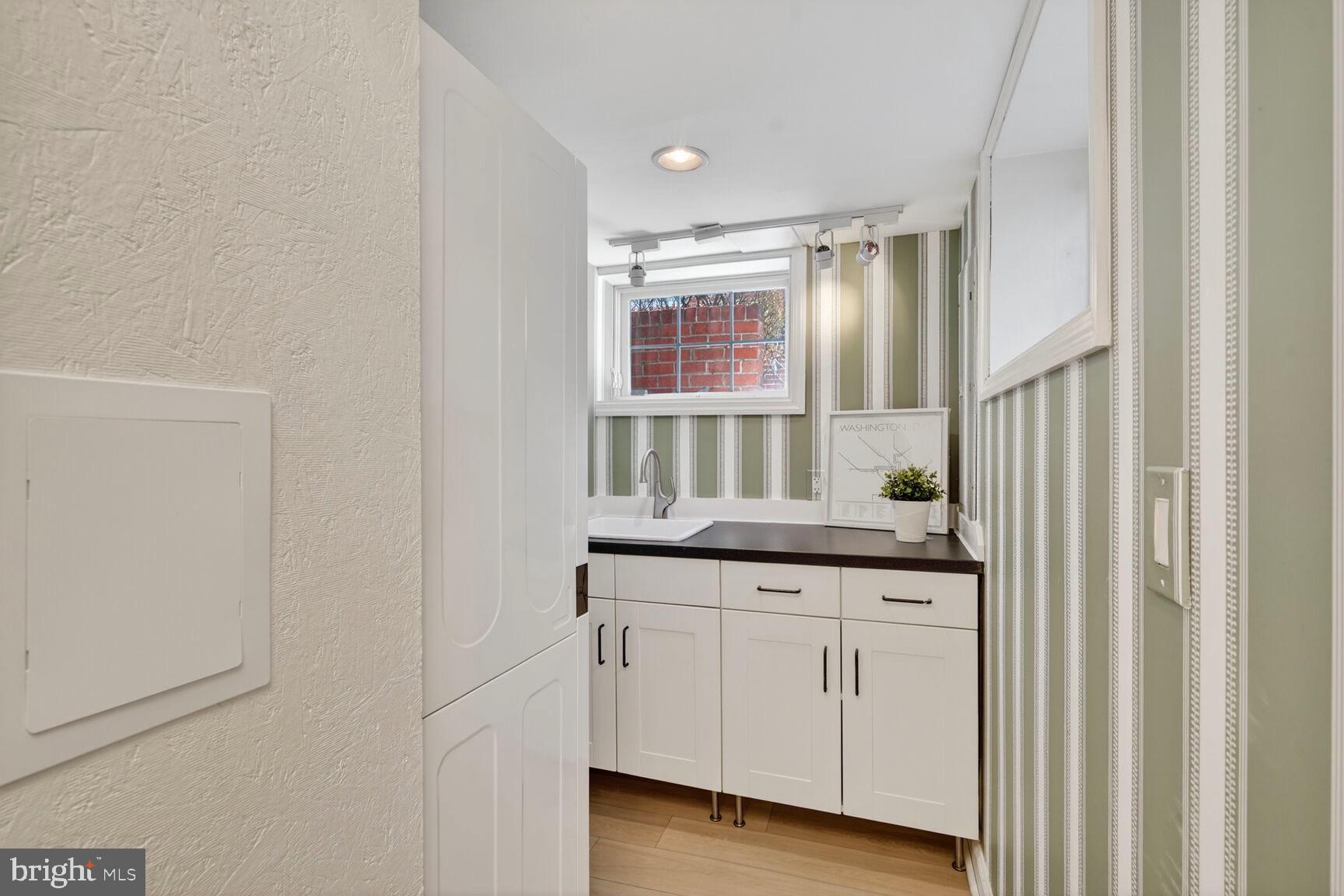 3262 Aberfoyle Place Northwest Washington, DC 20015 - Photo 45 of 64 a kitchen with white cabinets and sink
