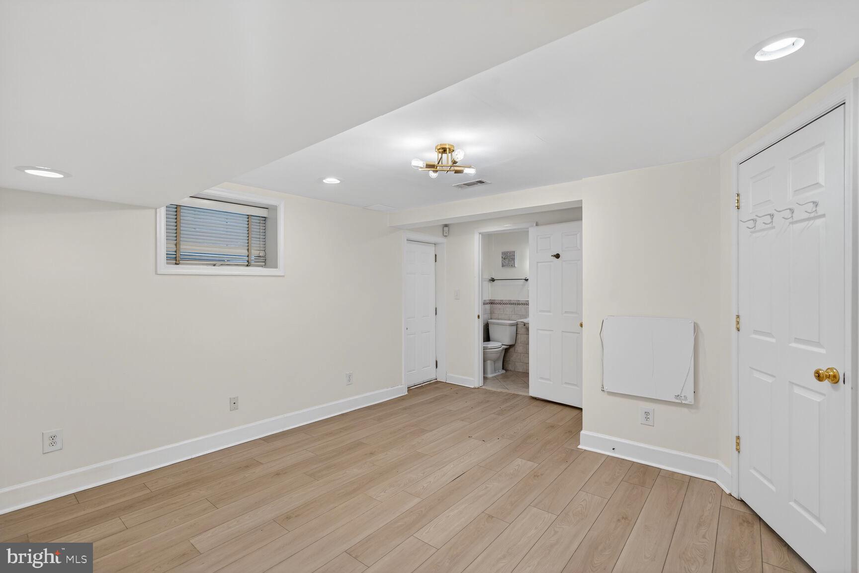 3262 Aberfoyle Place Northwest Washington, DC 20015 - Photo 53 of 64 an empty room with wooden floor and windows