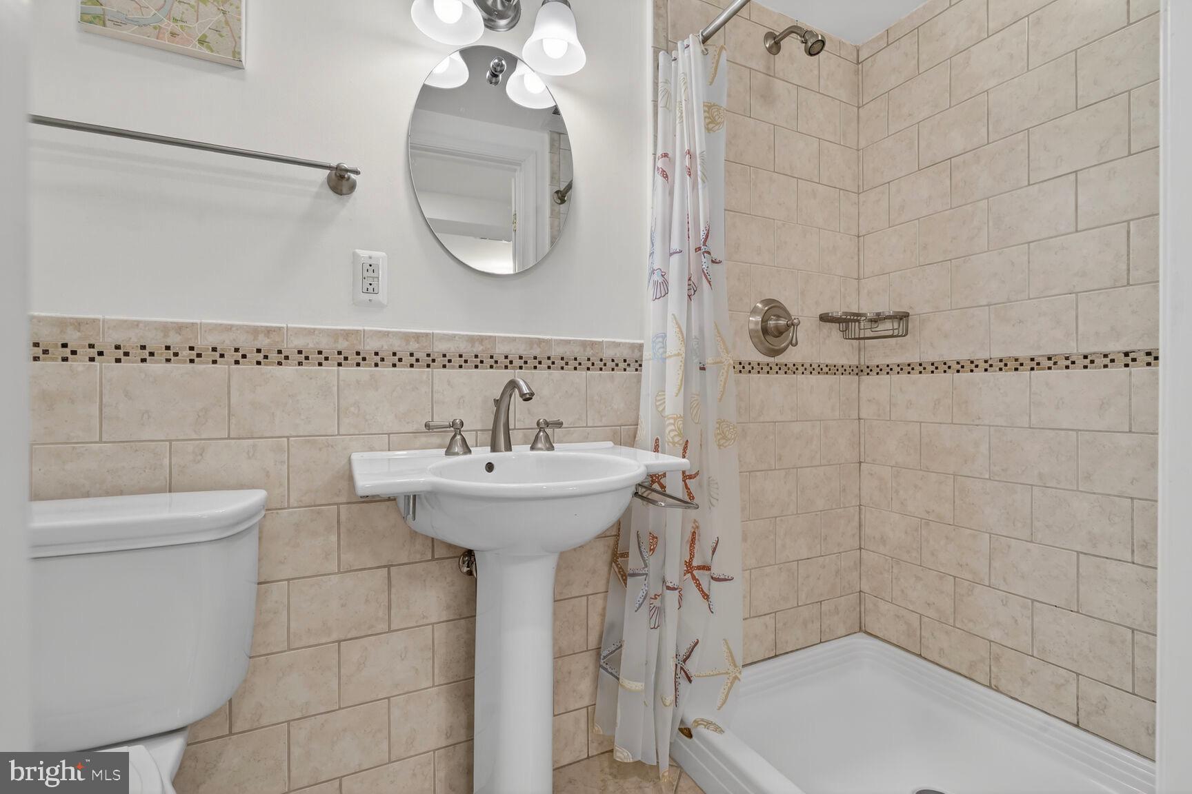 3262 Aberfoyle Place Northwest Washington, DC 20015 - Photo 54 of 64 a bathroom with a sink a toilet and shower