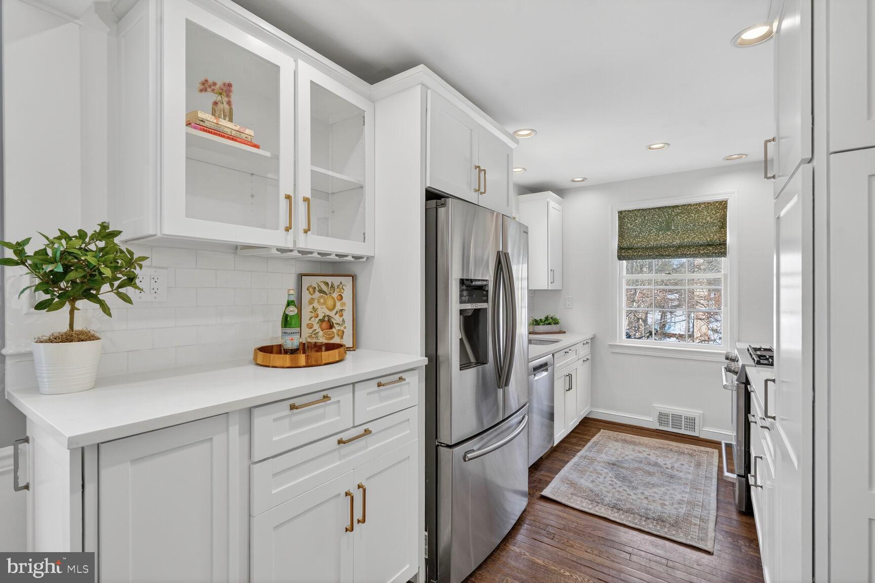 3262 Aberfoyle Place Northwest Washington, DC 20015 - Photo 8 of 64 a kitchen with stainless steel appliances a refrigerator and a counter space