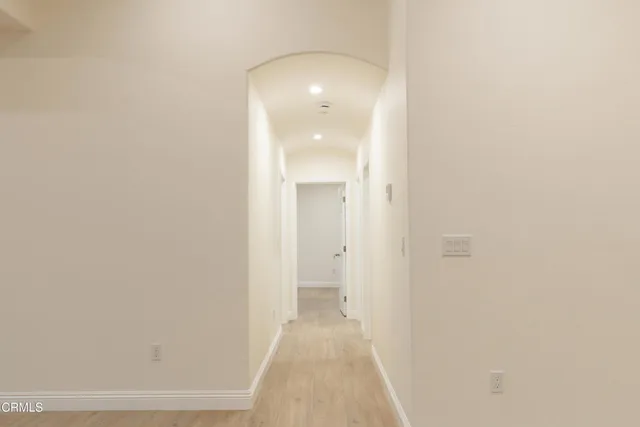 a view of a hallway with wooden floor