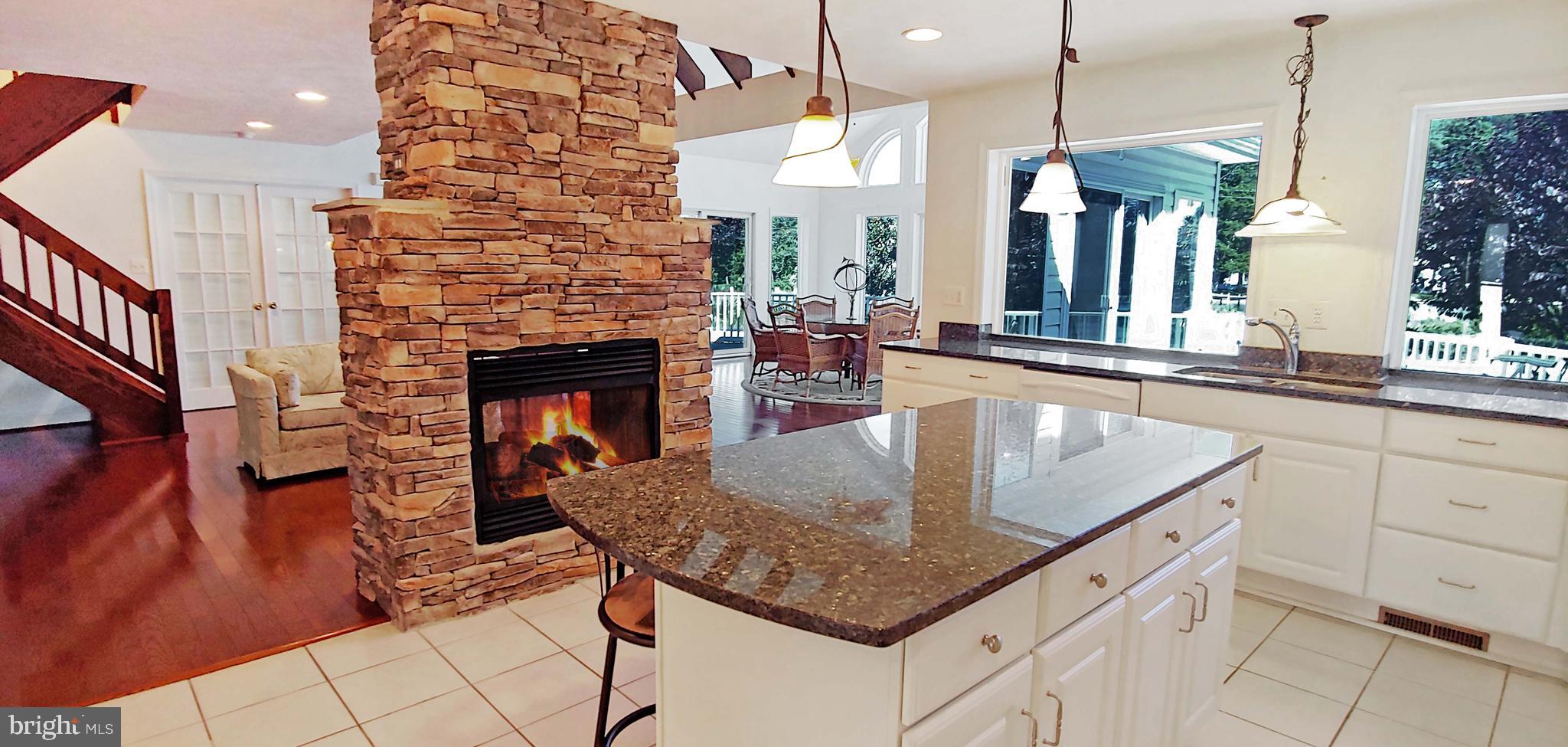 17451 Poplar Street Piney Point, MD 20674 - Photo 21 of 67 Double-sided Fireplace from Kitchen Side