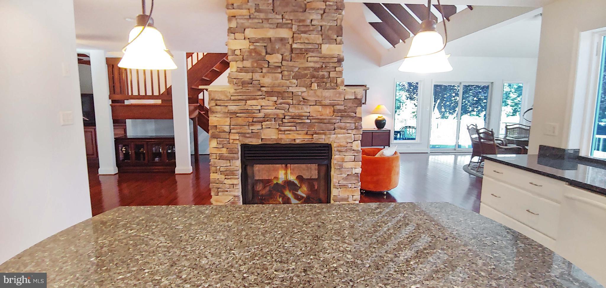 17451 Poplar Street Piney Point, MD 20674 - Photo 22 of 67 Double-sided Fireplace from Kitchen Side