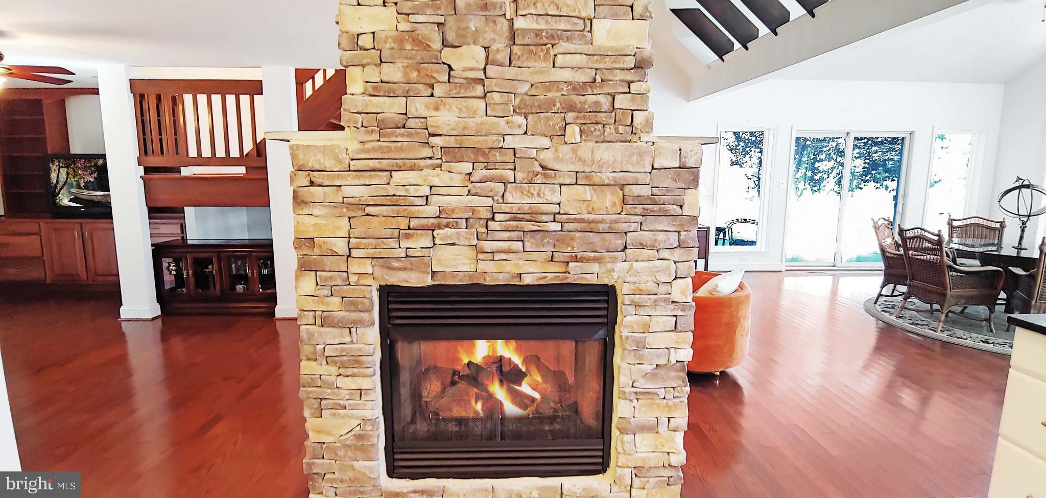 17451 Poplar Street Piney Point, MD 20674 - Photo 23 of 67 Double-sided Fireplace from Kitchen Side