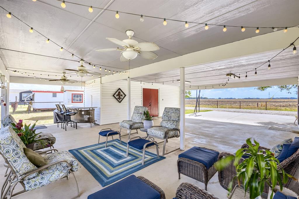 626 Epps Road Palmer, TX 75152 - Photo 37 of 40 Expansive covered patio featuring a concrete surface, multiple ceiling fans, and string lighting
