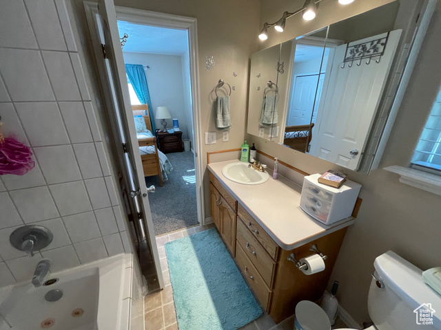11473 South Dempsey Creek Road Lava Hot Springs, ID 83246 - Photo 20 of 47 Full bath with ensuite bath, vanity, tile patterned flooring, and bathing tub / shower combination