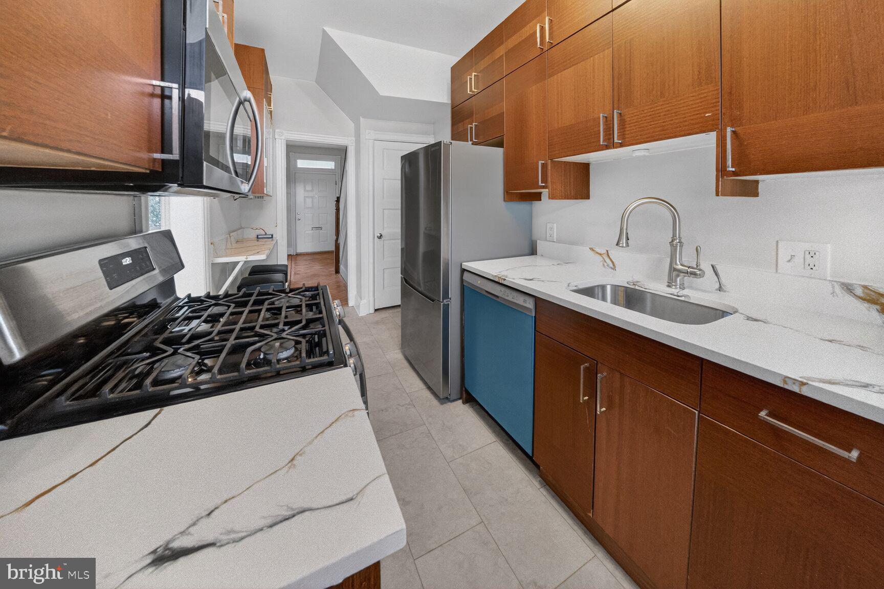 1932 Summit Place Northeast Washington, DC 20002 - Photo 11 of 26 a kitchen with a sink a stove and refrigerator