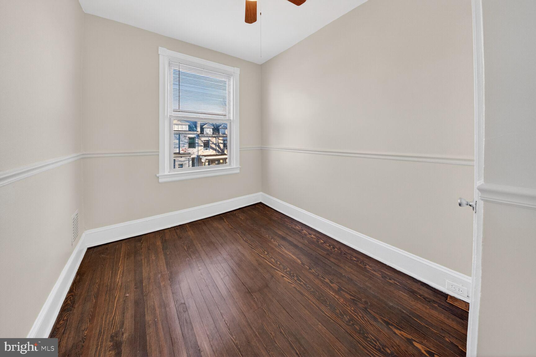 1932 Summit Place Northeast Washington, DC 20002 - Photo 15 of 26 an empty room with wooden floor and windows