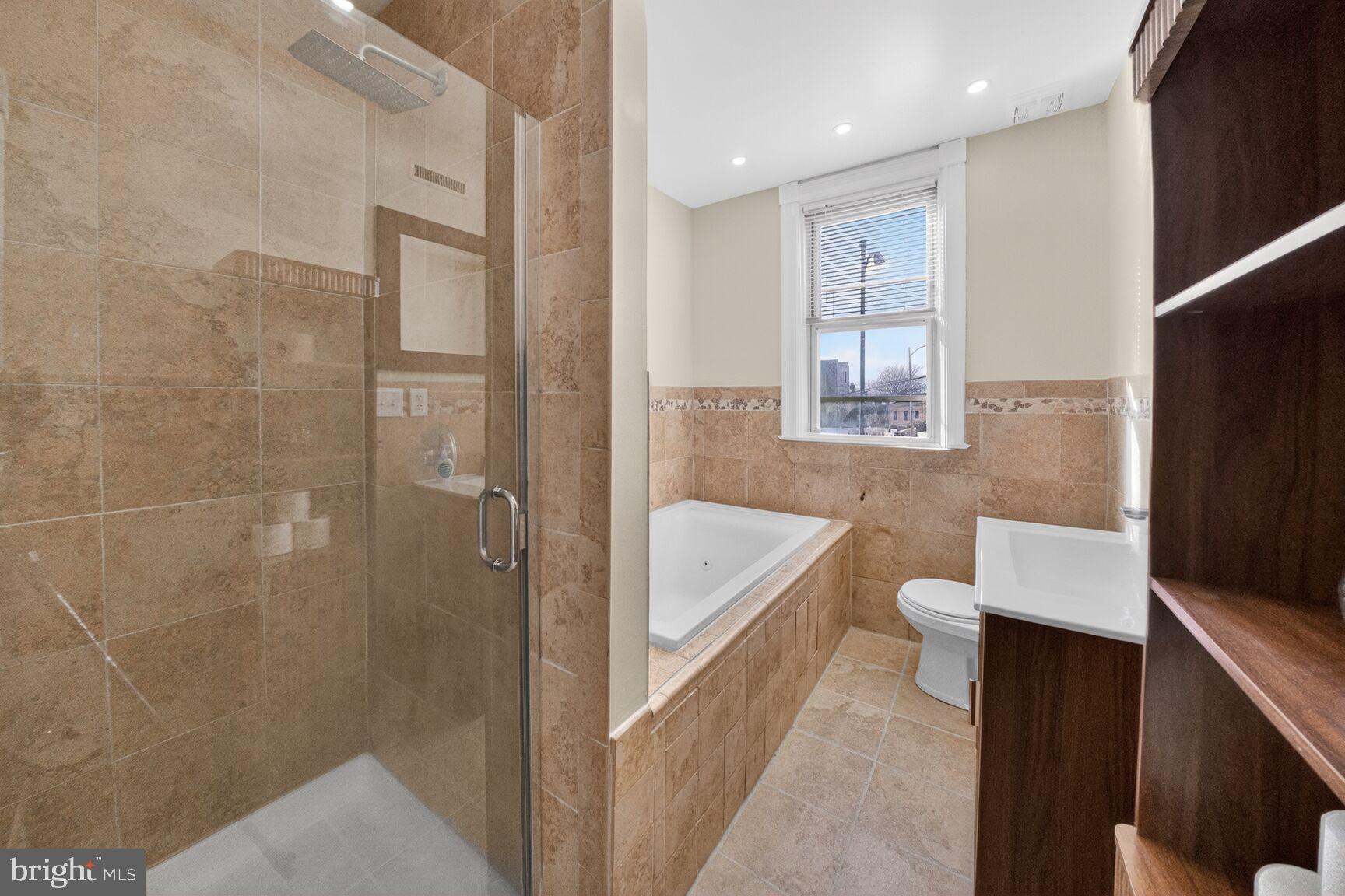 1932 Summit Place Northeast Washington, DC 20002 - Photo 16 of 26 a bathroom with a bathtub shower sink mirror and toilet