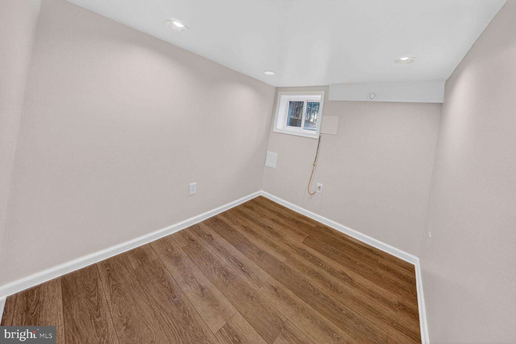 1932 Summit Place Northeast Washington, DC 20002 - Photo 22 of 26 a view of room with wooden floor and white walls