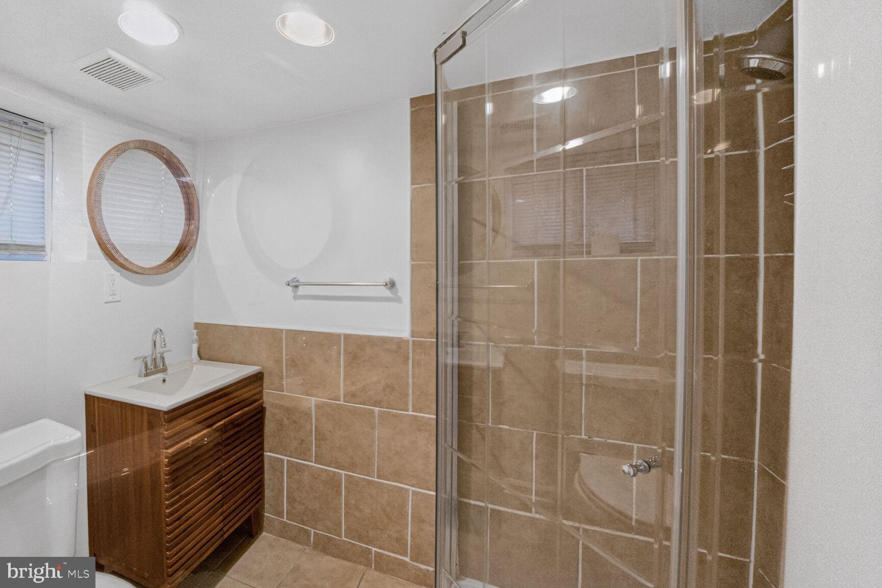 1932 Summit Place Northeast Washington, DC 20002 - Photo 23 of 26 a bathroom with a mirror and a shower