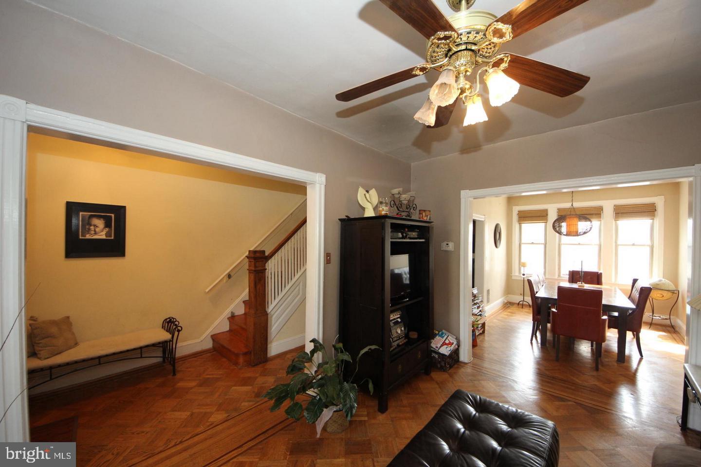 1932 Summit Place Northeast Washington, DC 20002 - Photo 5 of 26 a view of a livingroom with furniture hardwood floor ceiling fan and a window