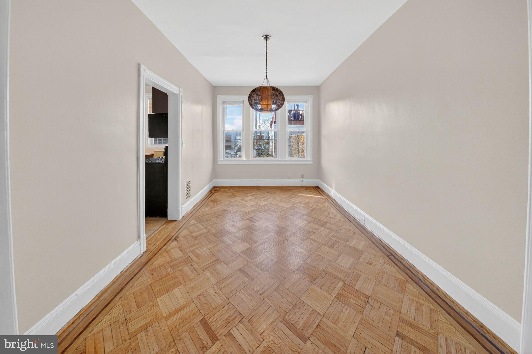 1932 Summit Place Northeast Washington, DC 20002 - Photo 8 of 26 a view of a hallway with wooden floor and a window