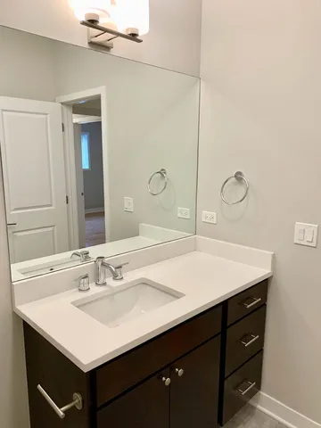 a bathroom with a sink vanity and a mirror