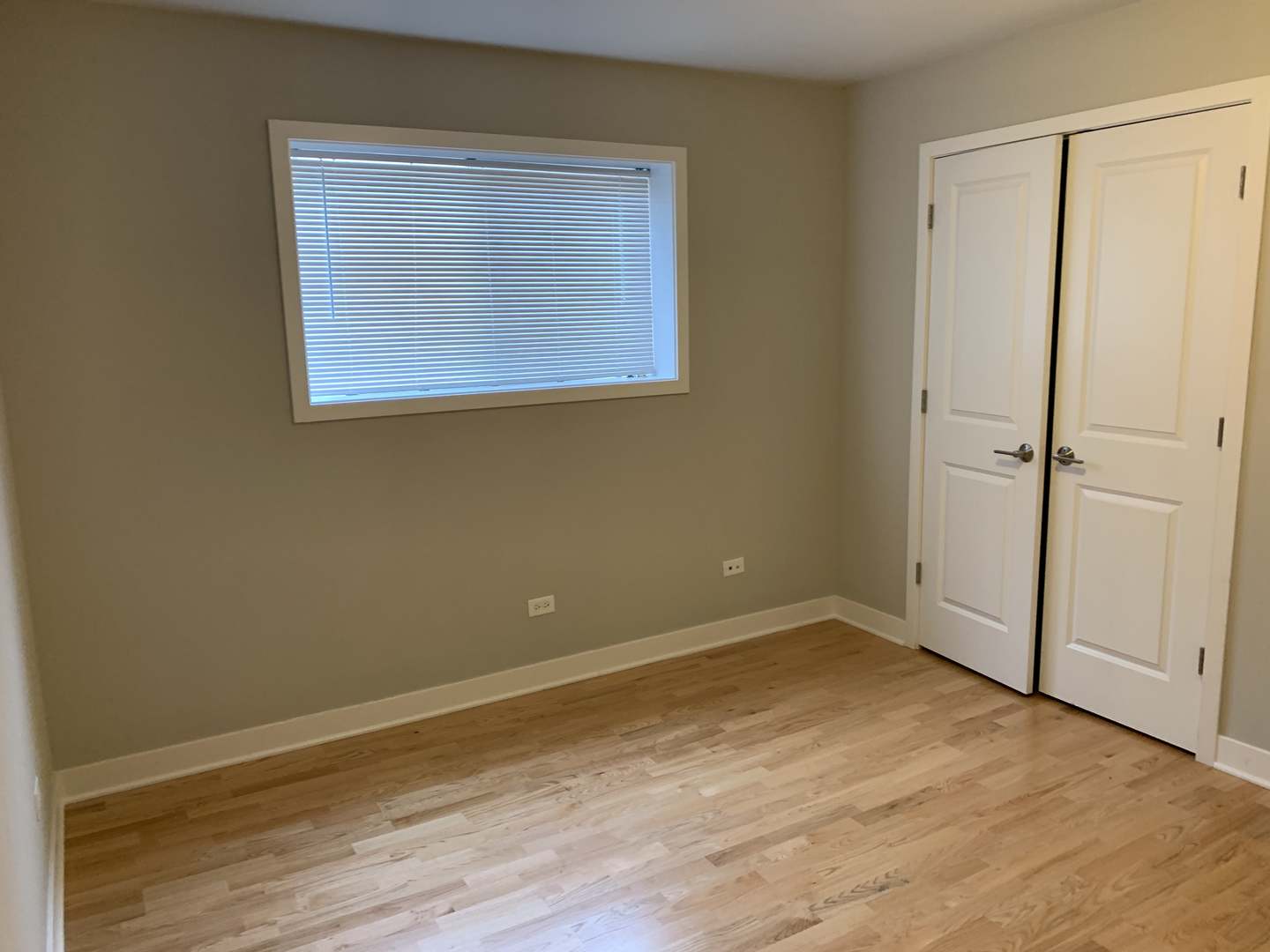 6125 North Clark Street, Unit 104 Chicago, IL 60660 - Photo 16 of 25 an empty room with wooden floor and windows