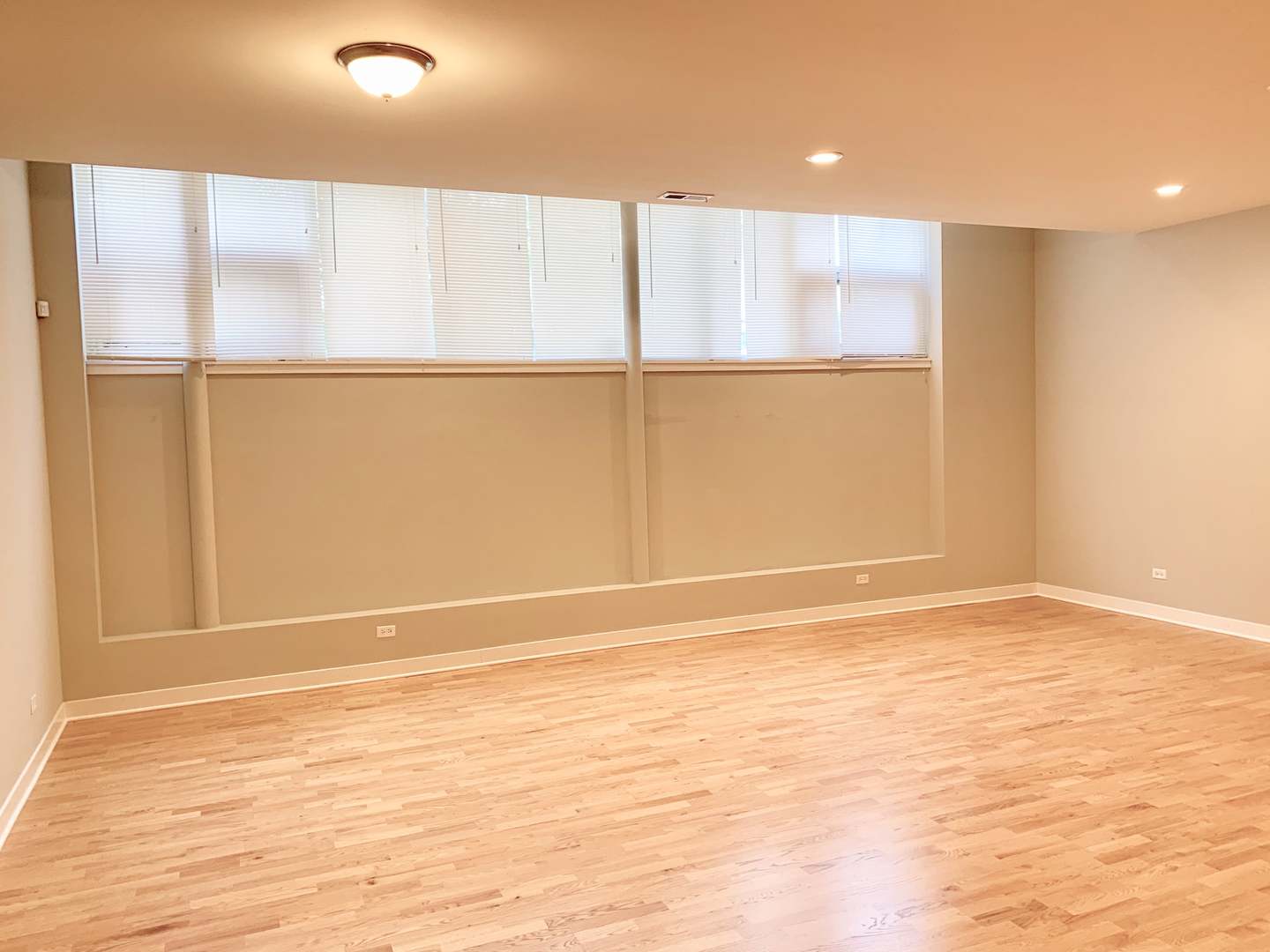 6125 North Clark Street, Unit 104 Chicago, IL 60660 - Photo 4 of 25 a view of an empty room with wooden floor and a window