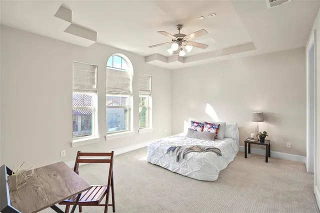 a bedroom with a bed and lamp chandelier