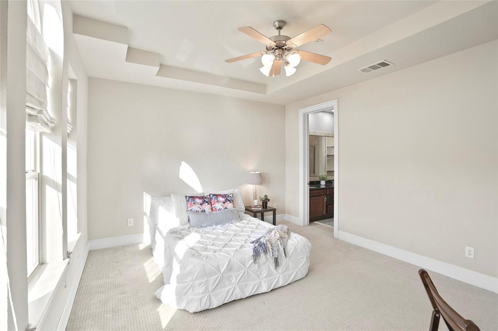6748 Plaza Via Irving, TX 75039 - Photo 12 of 31 a bedroom with a bed and a chandelier